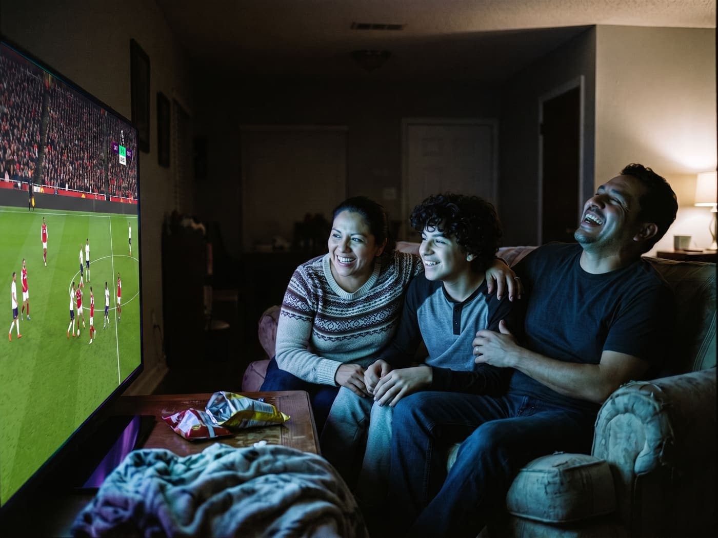 A family watching a football match at home